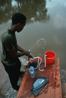 Filtering Sanga River water, Congo (DI00760), Photo by Lee Klinger